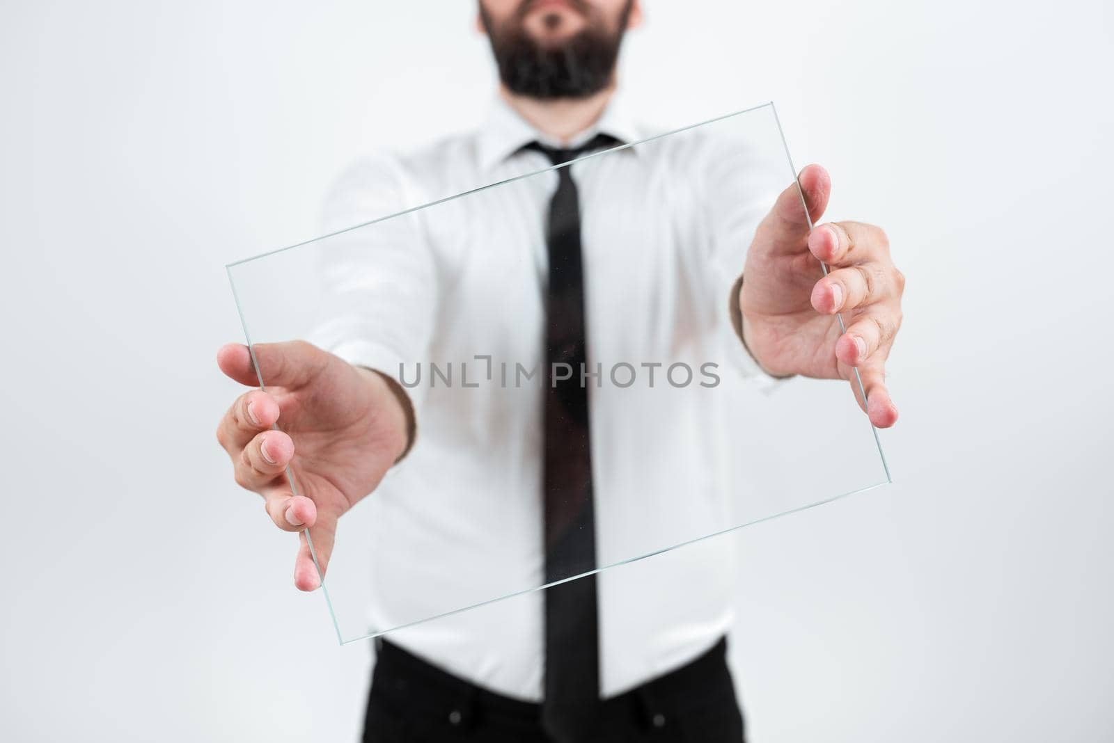 Male Corporate Holding Transparent Glass And Presenting Important Sales Data. Man Wearing Necktie Displaying New Ideas And Strategies For Achieving The Business Goals. by nialowwa