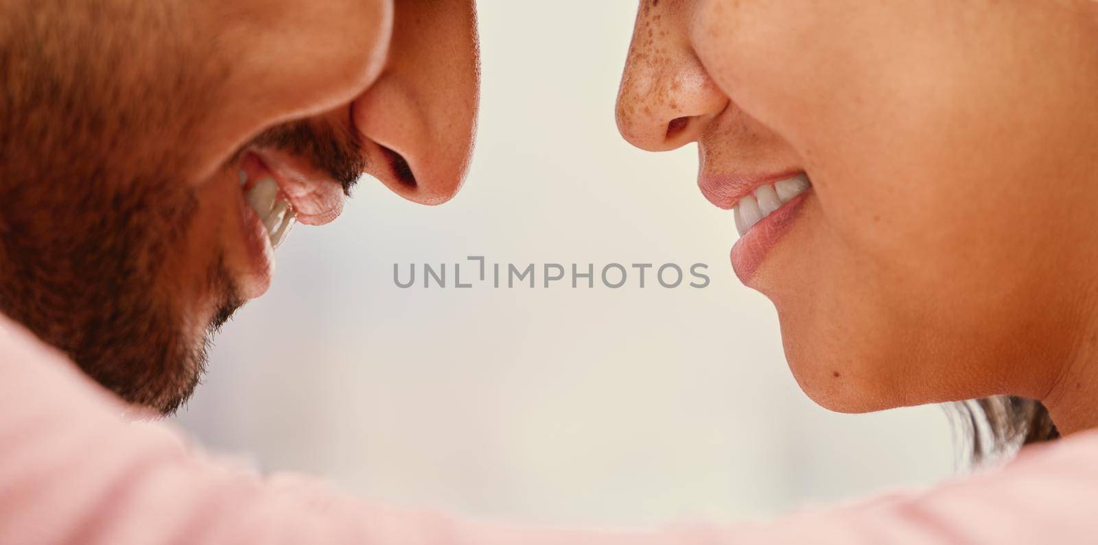 Closeup of mixed race man loving his asian wife. Headshot of hispanic couple bonding and sharing an intimate moment at home. Beautiful woman with freckles feeling in love with boyfriend.