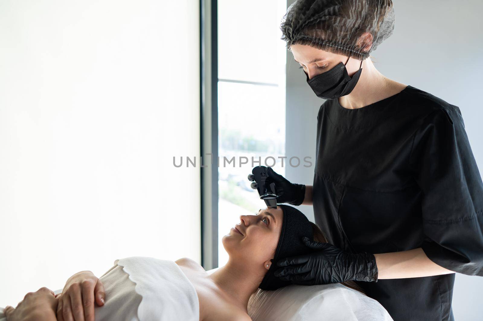 Woman on ultrasonic cleaning procedure. Hardware cosmetology