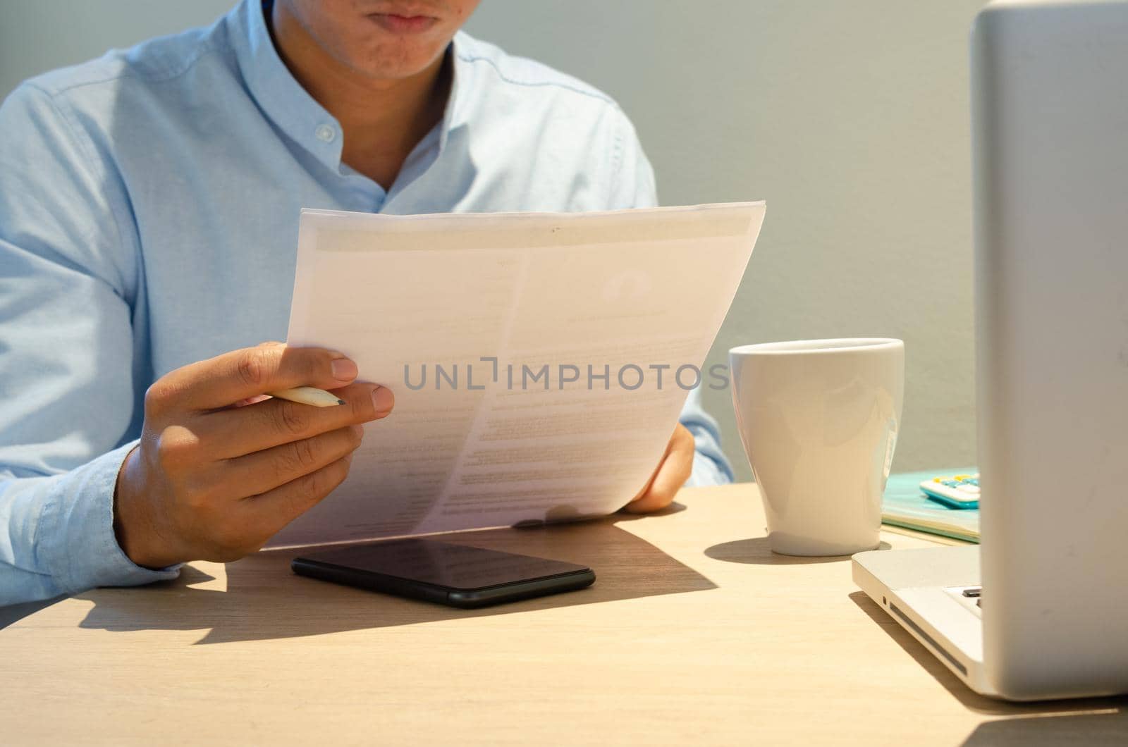 Businessman holding paperwork document finance investment and marketing concept with computer laptop on desk. by aoo3771