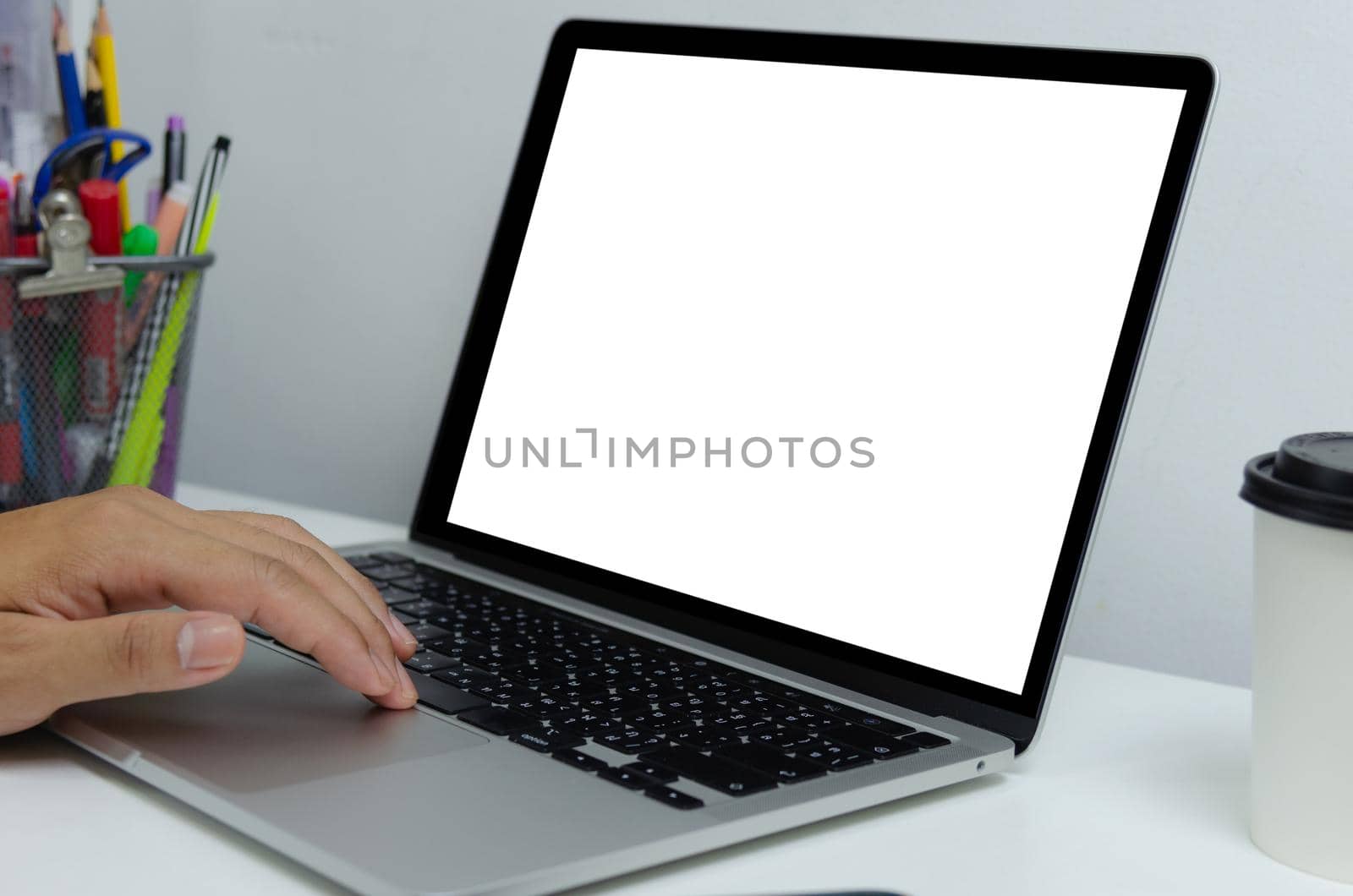 Hand man using keyboard computer laptop mock up blank white screen monitor technology online internet digital advertising business concept. by aoo3771
