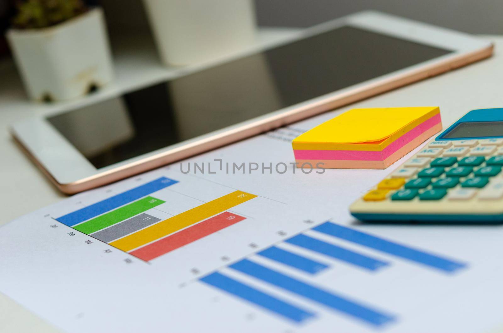 Business document chart and graph analysis finance information investment report on desk at office. by aoo3771