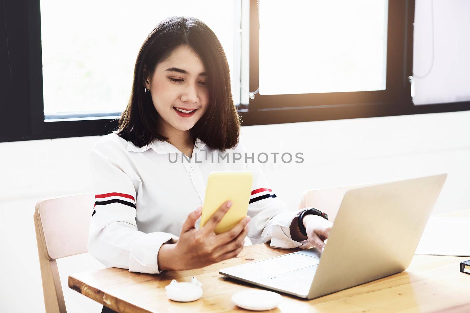 freelance concept,female using smartphone and computers to design work as ordered by customers. by Manastrong