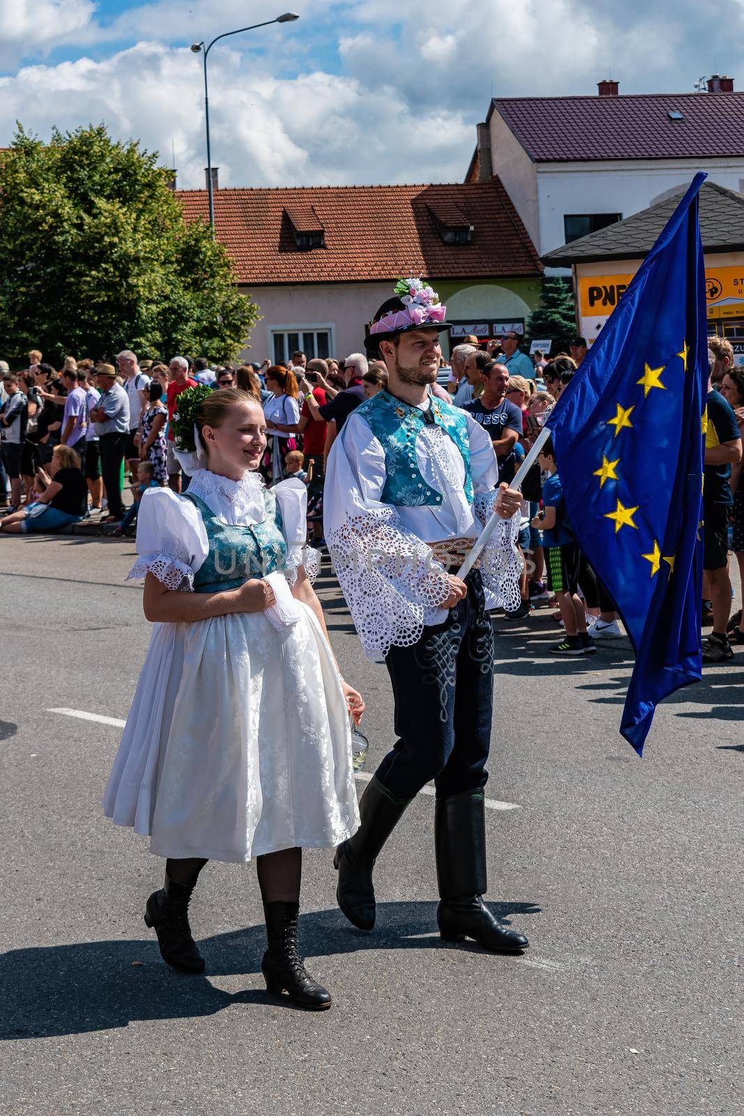 Boy and girl with the EU flag in folk costumes by rostik924
