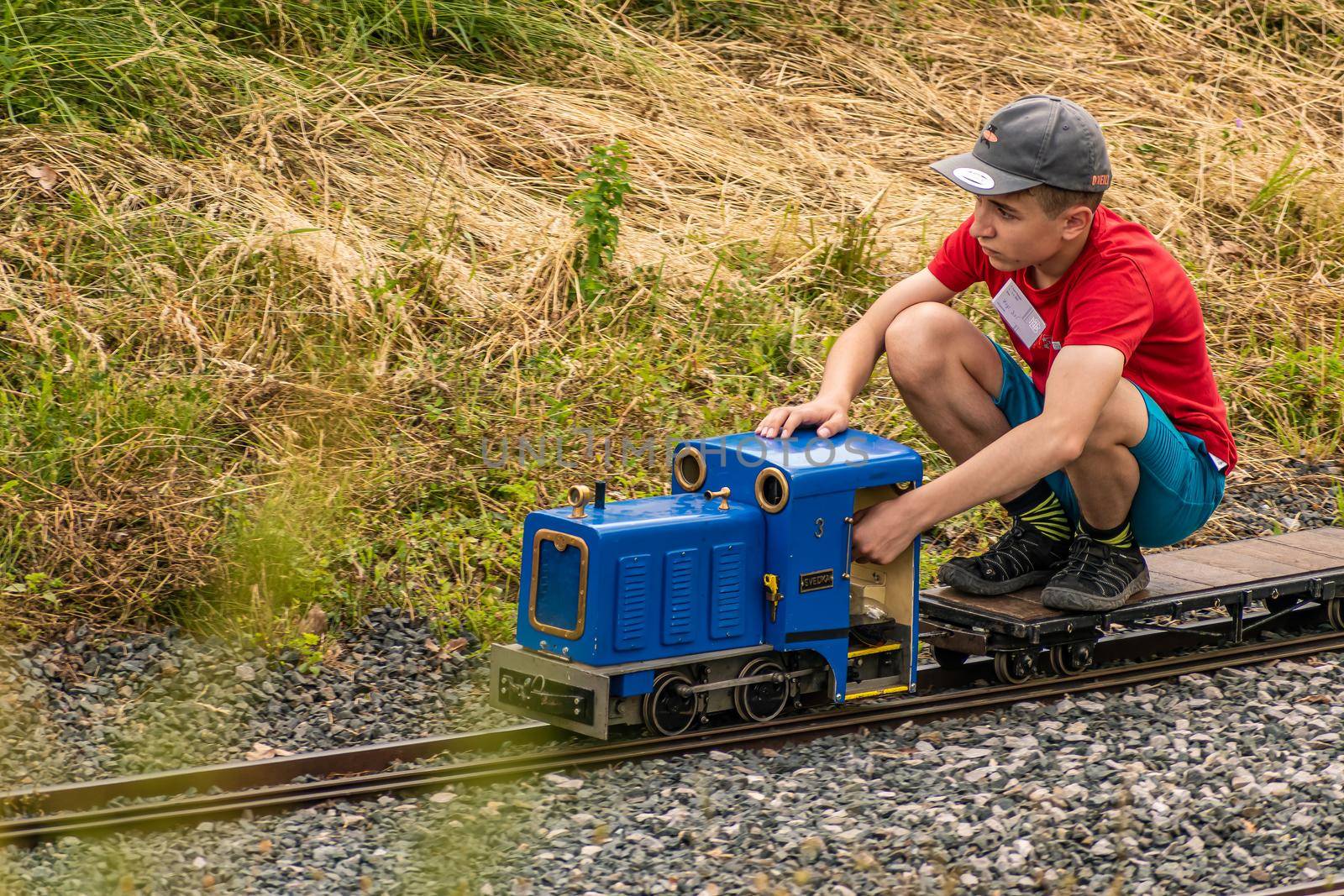 A boy drives a model of a motor locomotive by rostik924