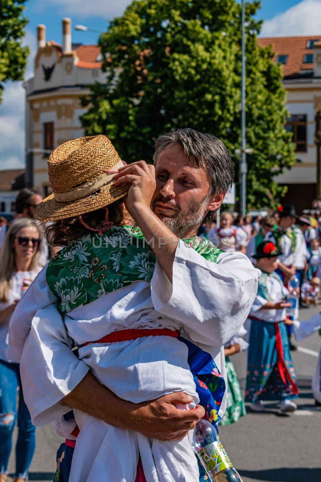 Straznice, Czech Republic - June 25, 2022 International Folklore Festival. A man with a child in his arms, in a folk costume
