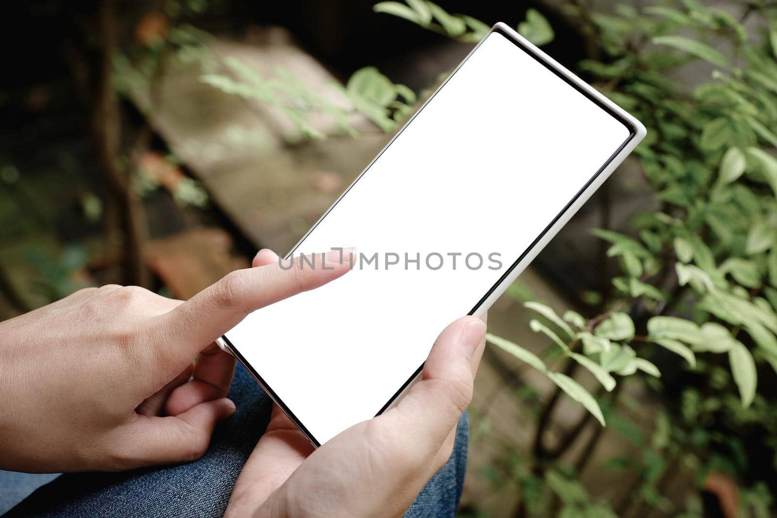 Woman hand holding smartphone Blank screen mobile phone for graphic display montage. by Manastrong