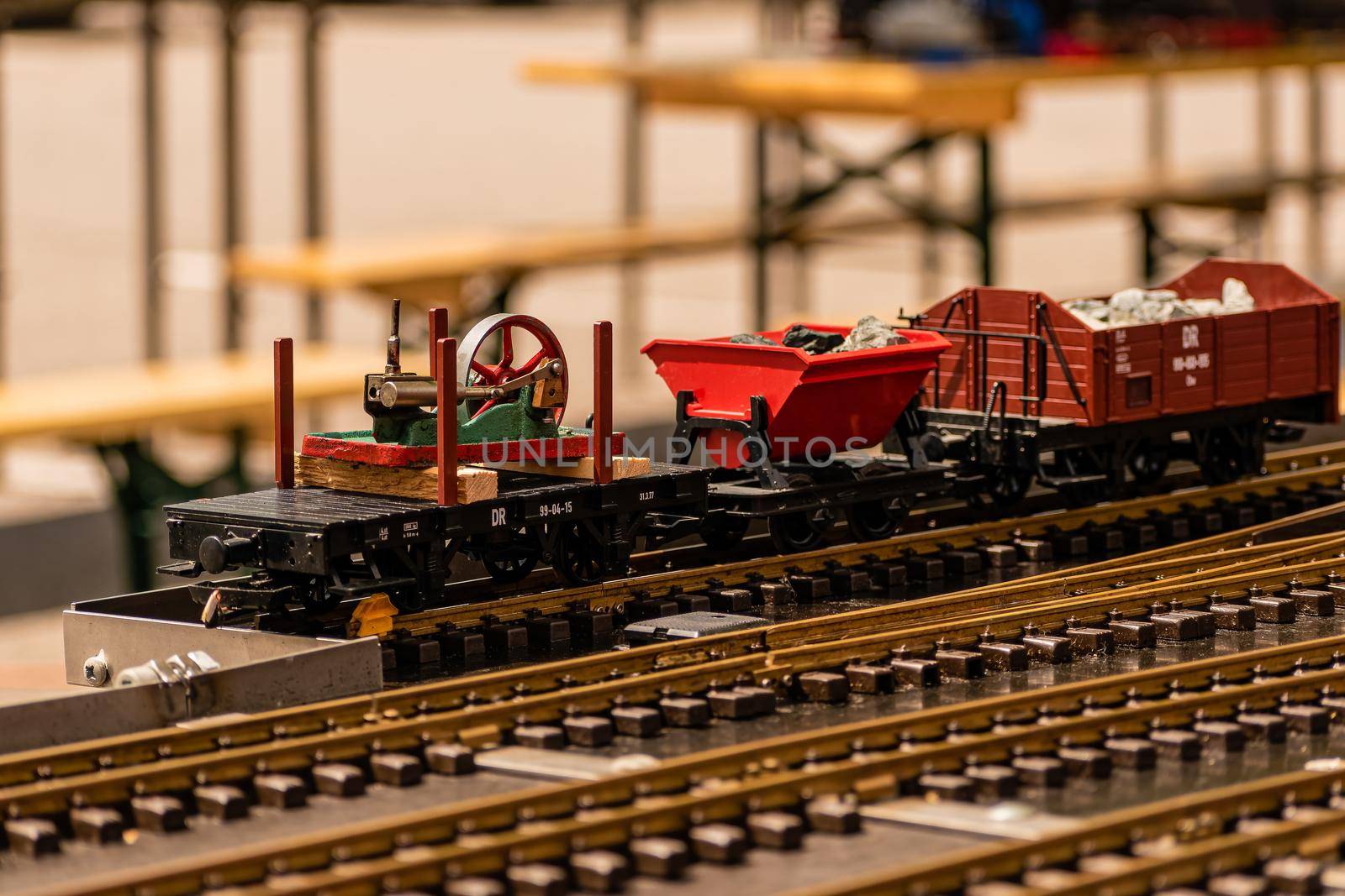 A small model of a steam locomotive on rails with wagons by rostik924