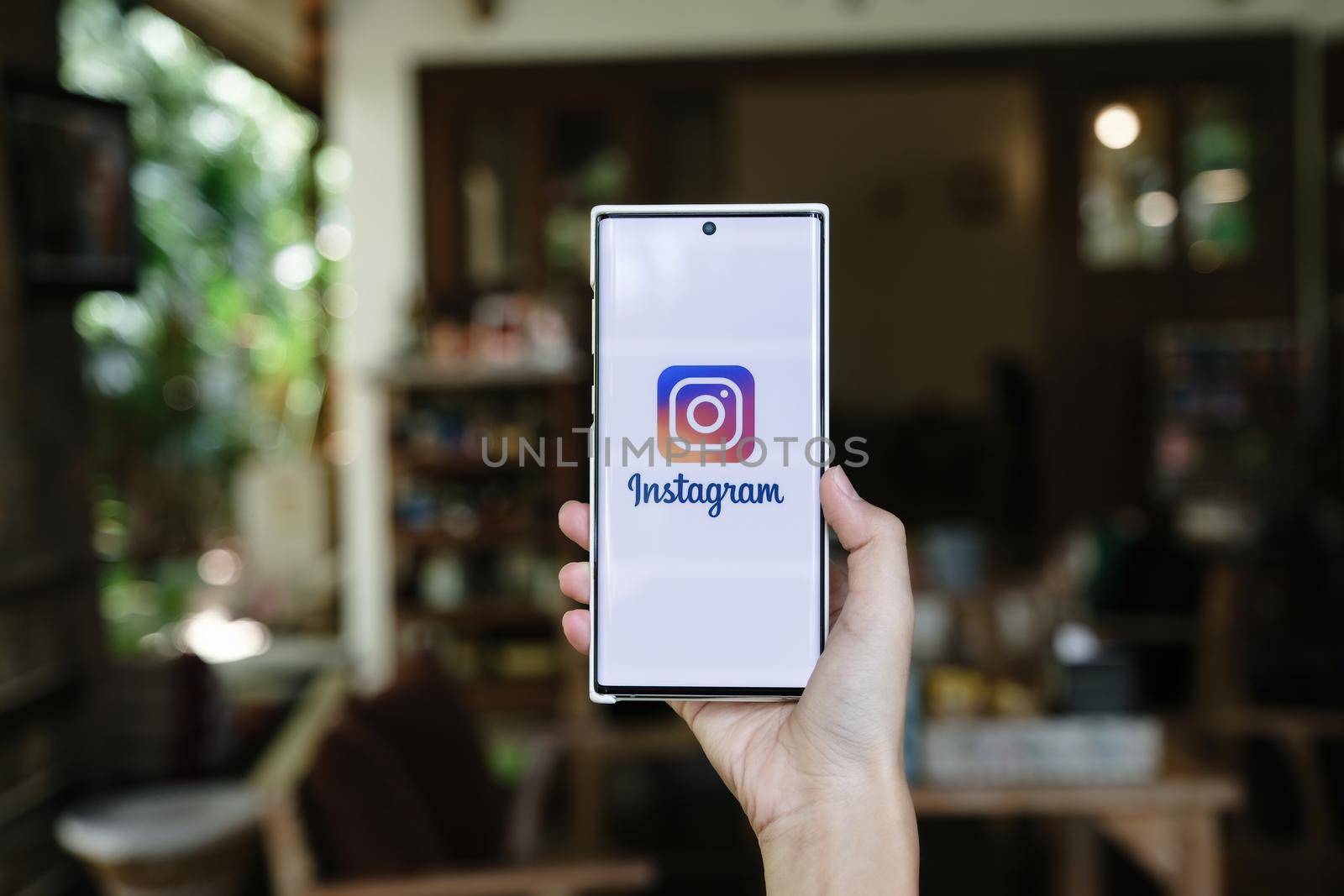 CHIANGMAI, THAILAND - July 09, 2021: A woman holding smartphone with Instagram application on the screen. Instagram is a photo sharing app for smartphones