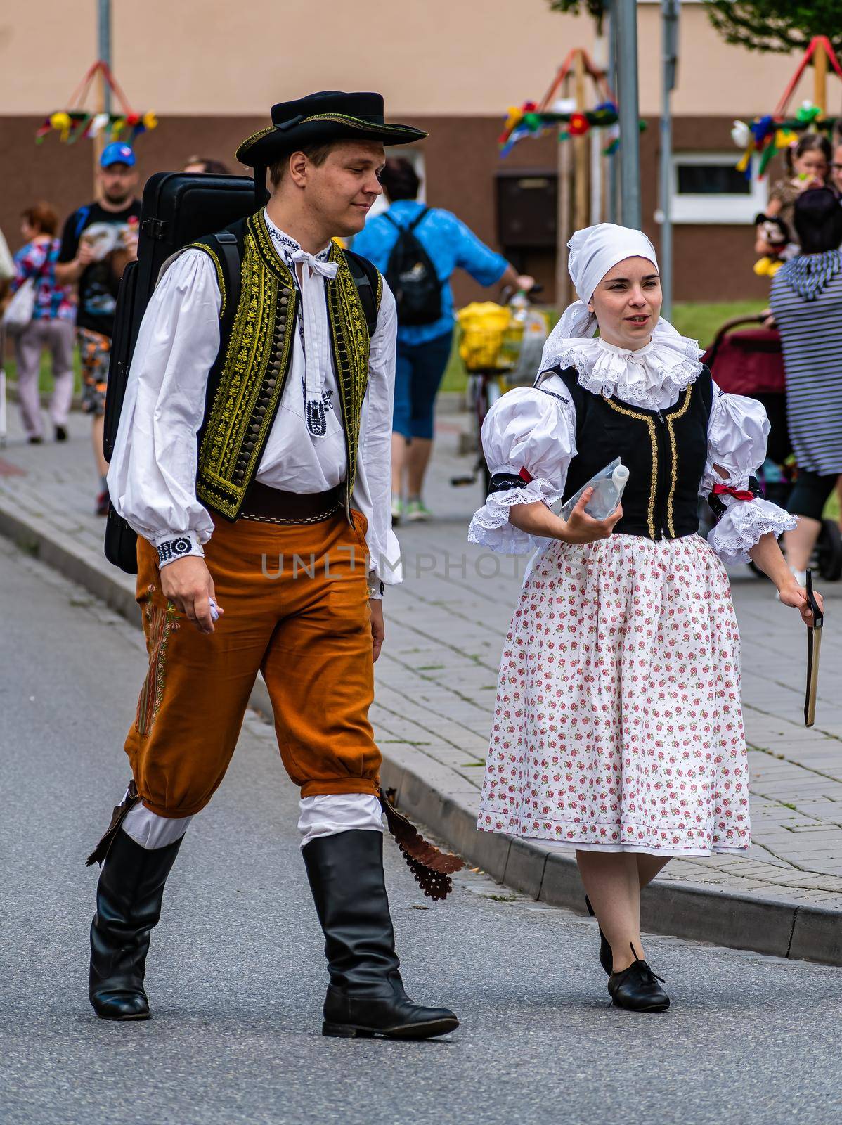 A woman and a man in folk costumes talk to each other by rostik924