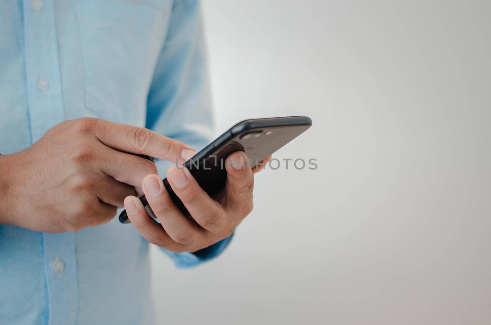 close up man hand holding mobile smartphone copy space.person texting text message internet technology concept.