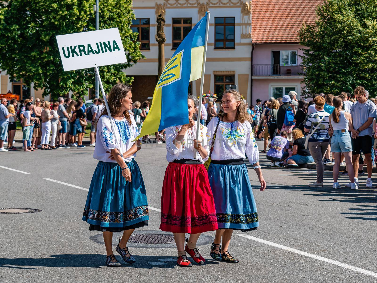 Straznice, Czech Republic - June 25, 2022 International Folklore Festival Three Ukrainian Girls with a Flag in Folk Costumes