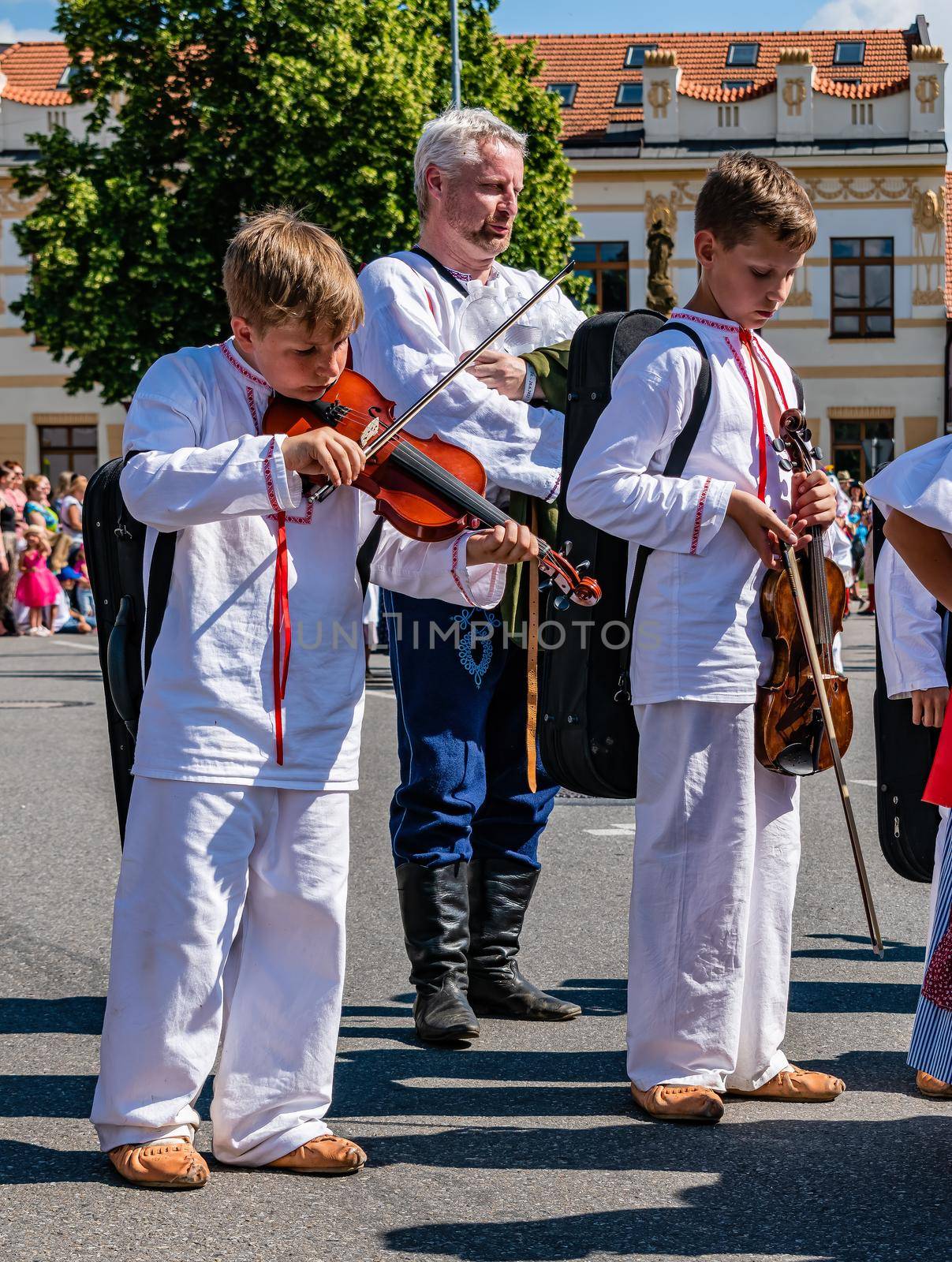 Straznice, Czech Republic - June 25, 2022 International Folklore Festival. Children in folk costumes play the violin