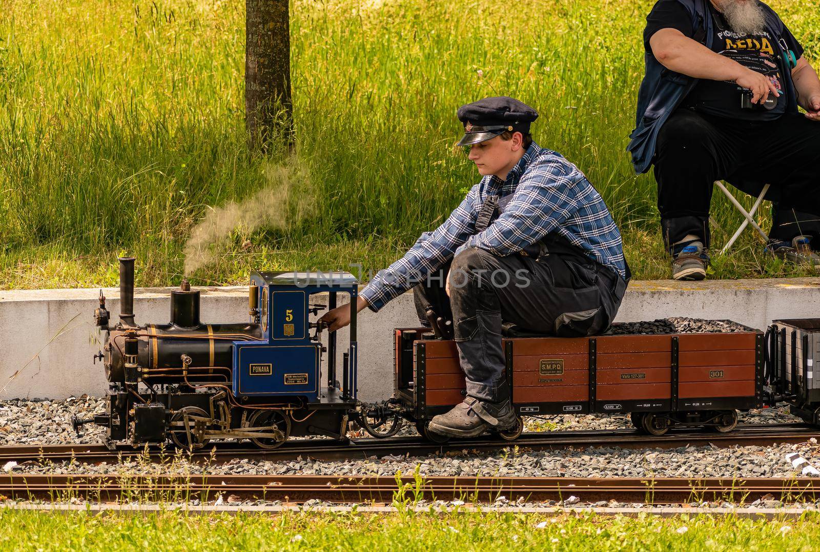 A man operates a model of a steam locomotive by rostik924