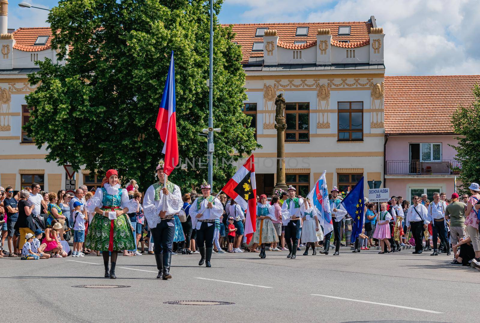 Front of the procession with flags in folk costumes by rostik924