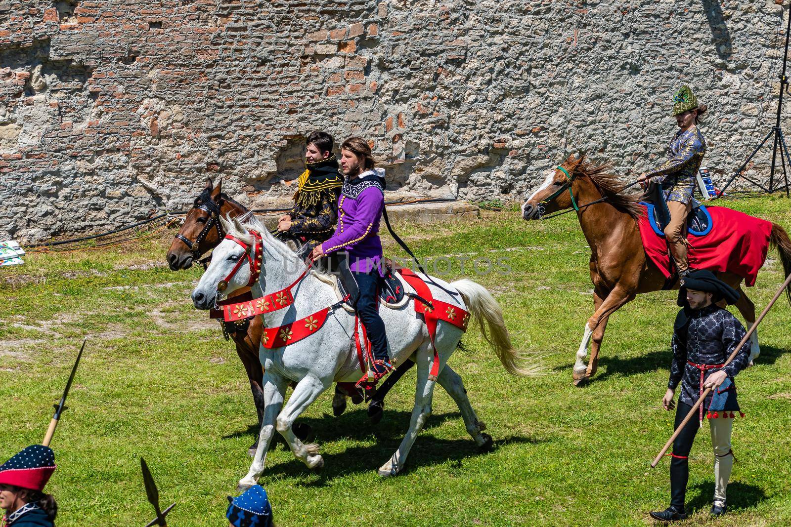 defile of knights in costumes on horseback by rostik924