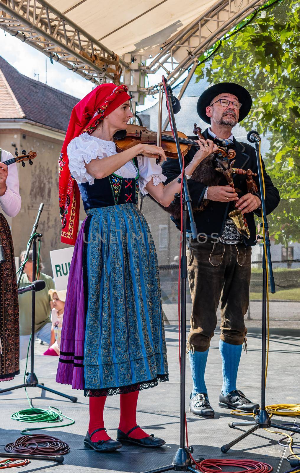 Straznice, Czech Republic - June 25, 2022 International Folklore Festival. Bagpiper and violinist on stage in Straznice