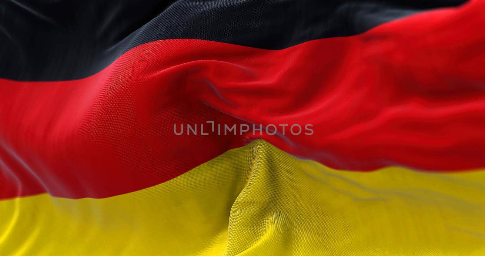 Close-up view of the German national flag waving in the wind. Germany is an European country.