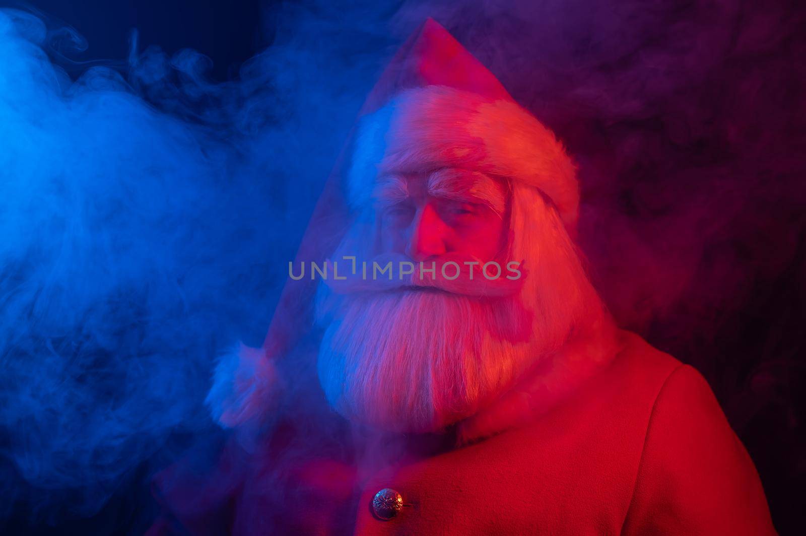 Santa claus in blue red smoke. Party for Christmas