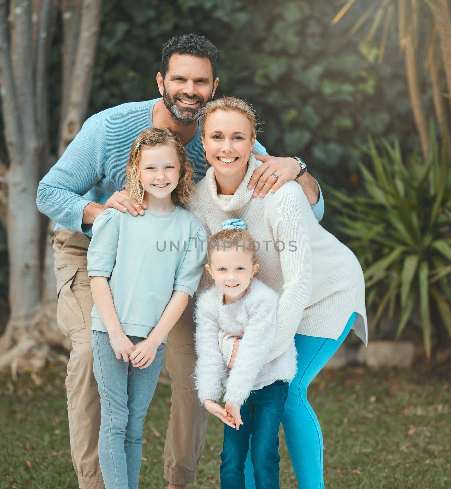 a family standing together in a yard.