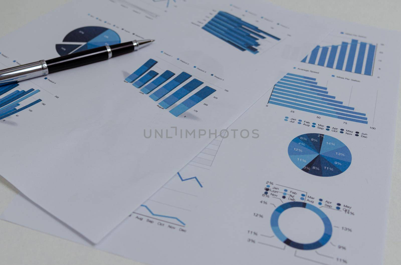 Business documents chart and graph finance statistic with pen.Paperwork report diagram investment and analysis information accounting marketing plan concept.