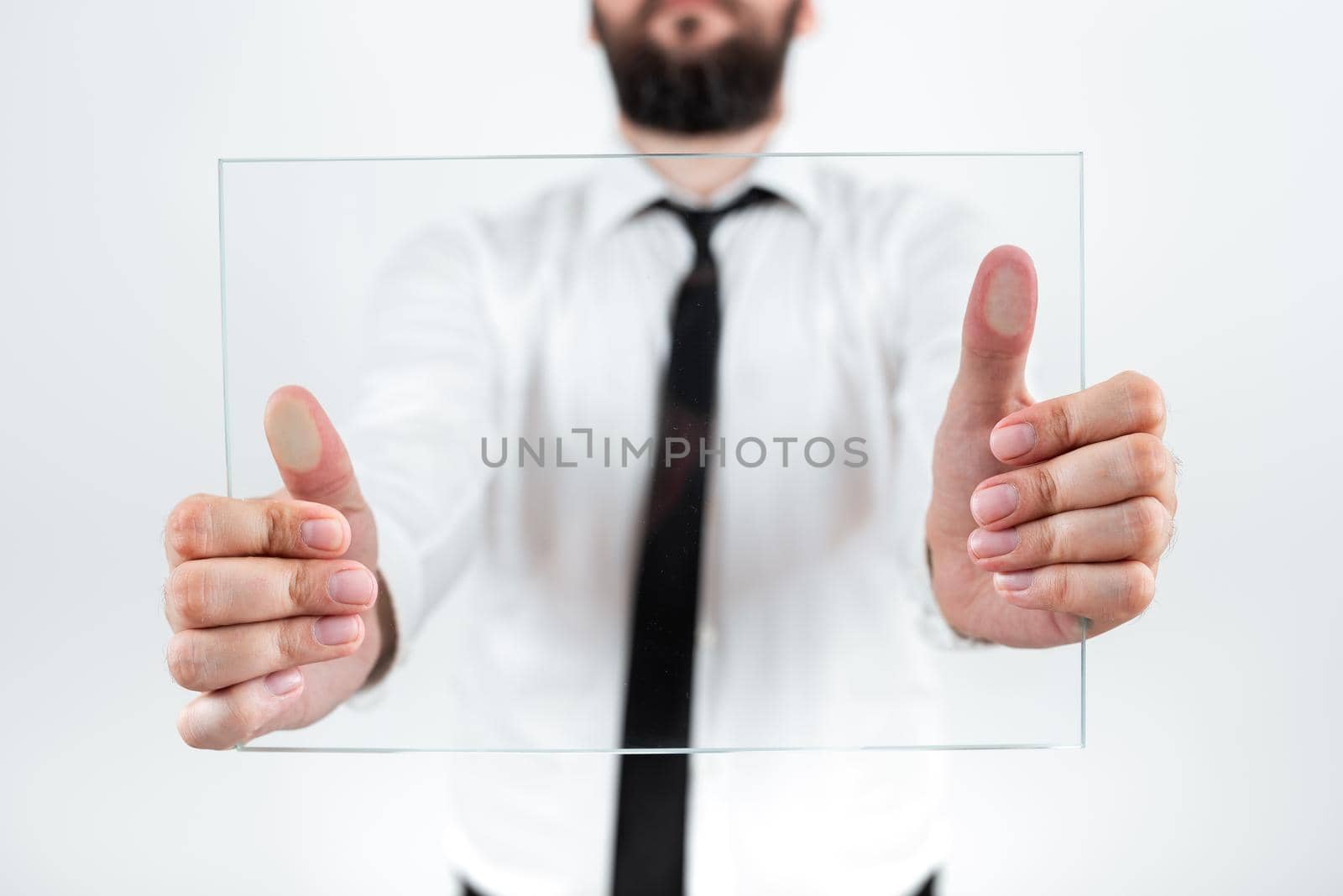 Male Corporate Holding Transparent Glass And Presenting Important Sales Data. Businessman Wearing Necktie Displaying New Ideas And Strategies For The Marketing. by nialowwa