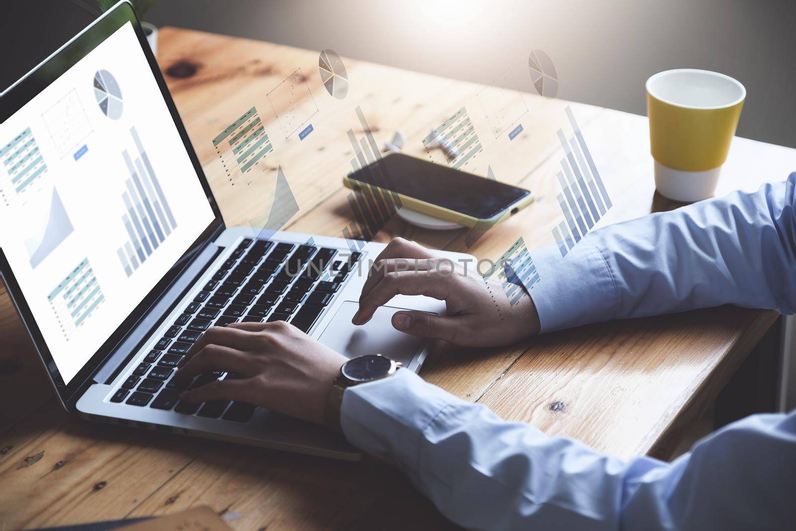 Business woman using computer to trade charts to find buy and sell points for her port. by Manastrong