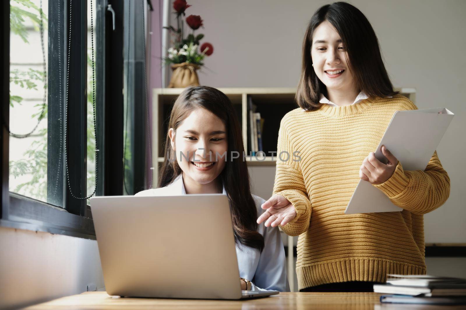 A female business consultant describes a marketing plan to set business strategies for women business owners. by Manastrong