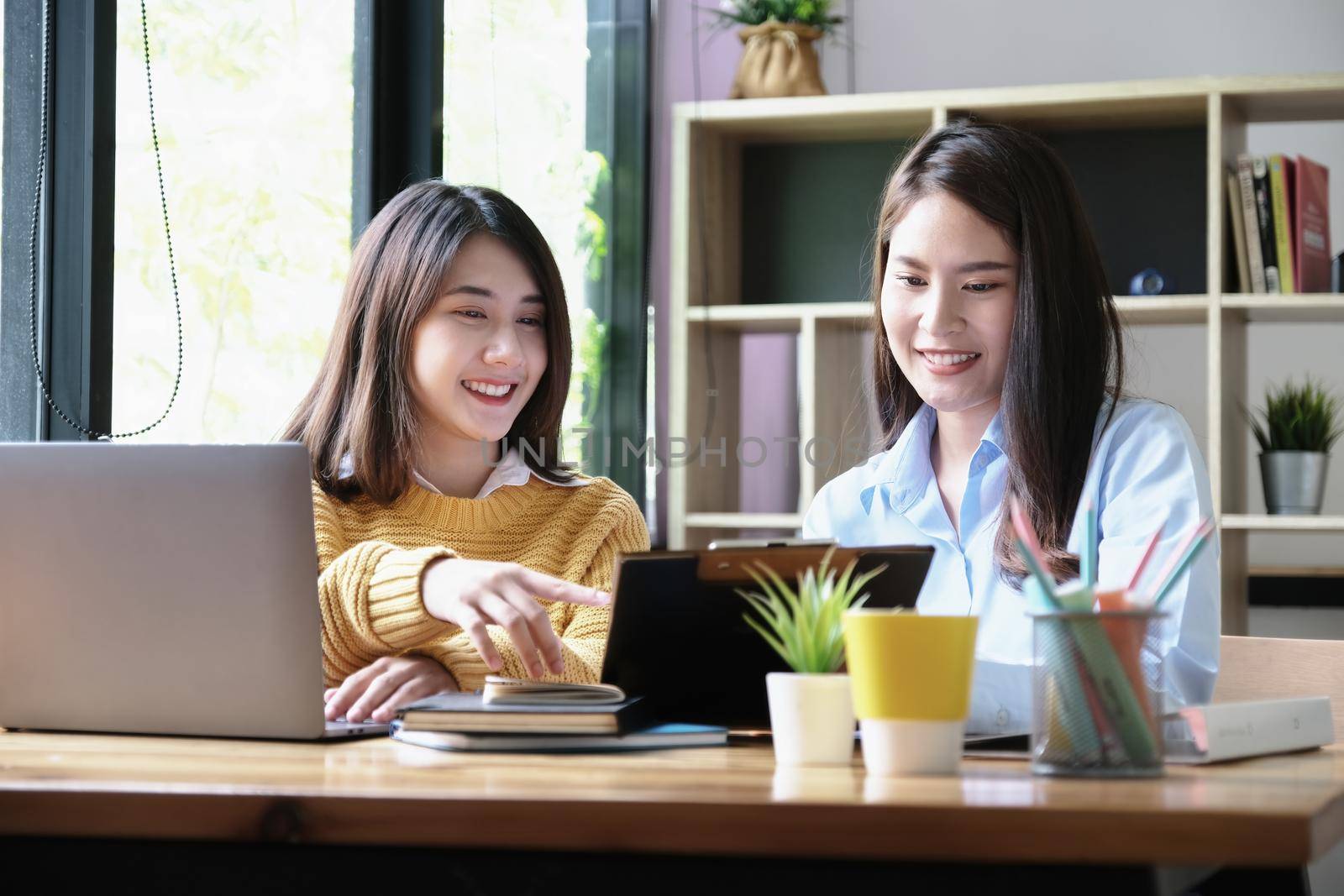 A female business consultant describes a marketing plan to set business strategies for women business owners. by Manastrong