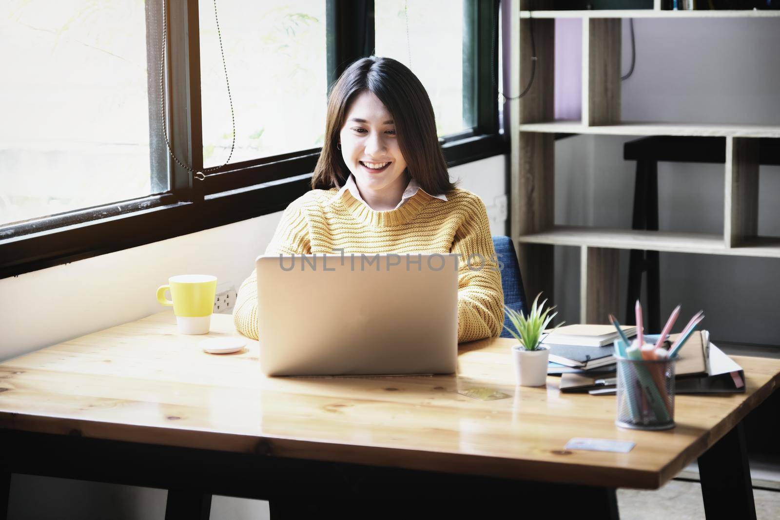 freelance concept,female using computers to design work as ordered by customers. by Manastrong