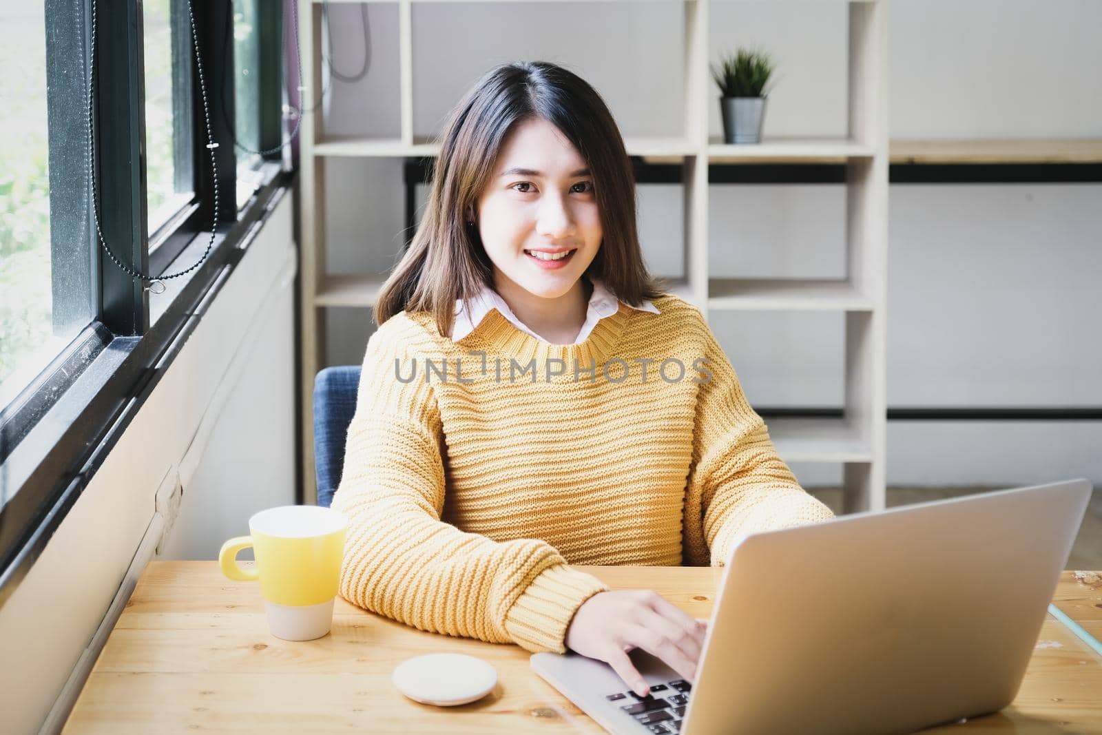 freelance concept,female using computers to design work as ordered by customers. by Manastrong