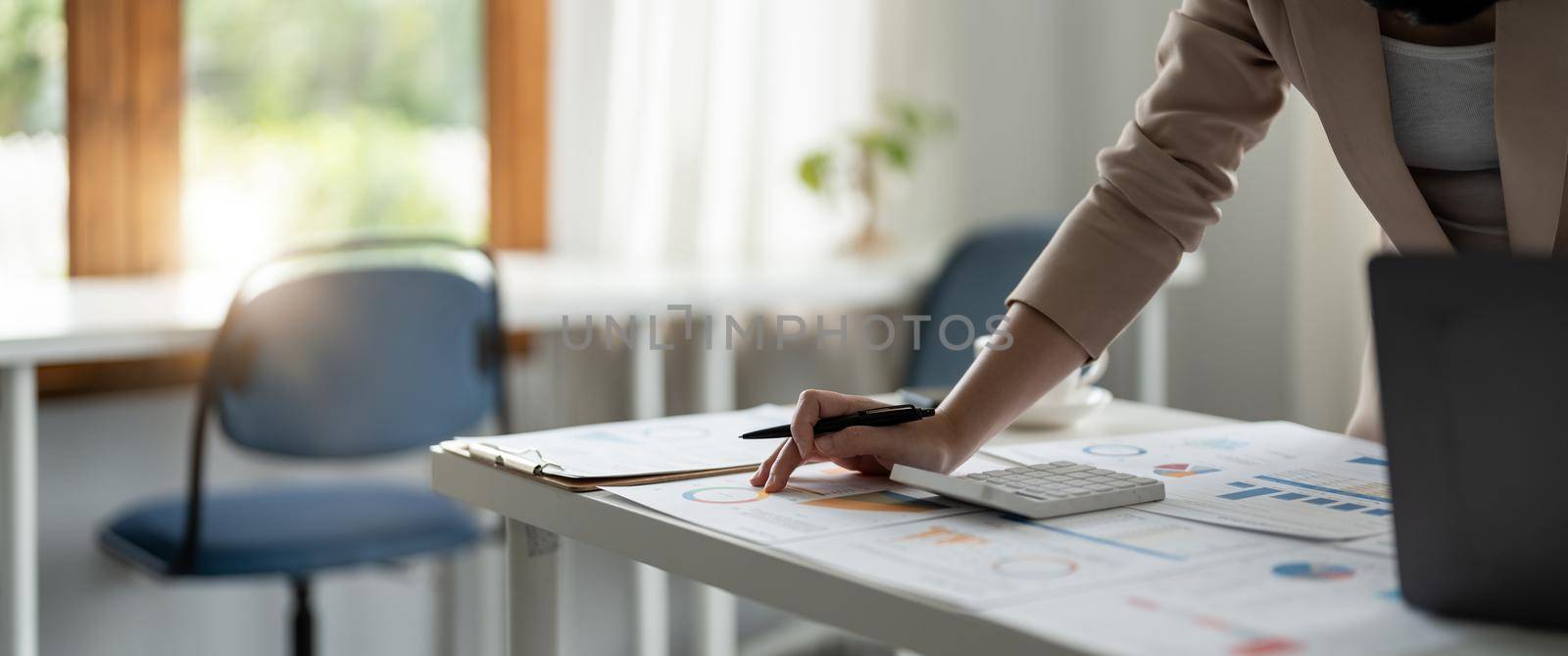 Close up hand of woman working about financial with calculator at his office to calculate expenses, Accounting concept.