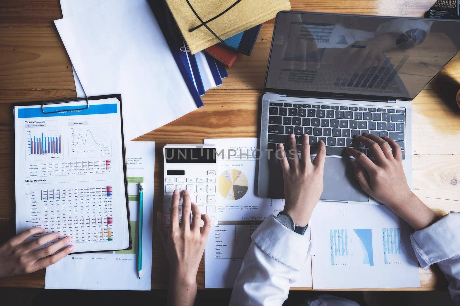 focus hand using calculator, Two young business executives are discussing to change their business concept to increase profits and the strength of their business with using calculator for work