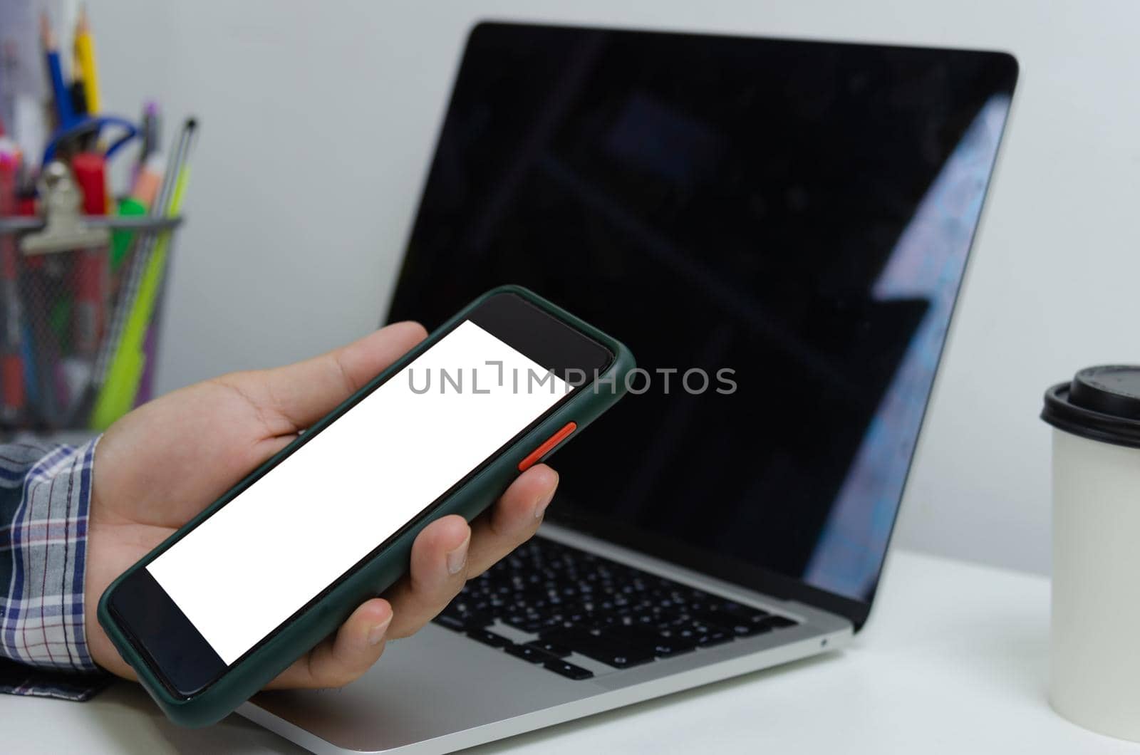 Hand man holding mobile smartphone mock up blank white screen technology online internet digital advertising business concept.