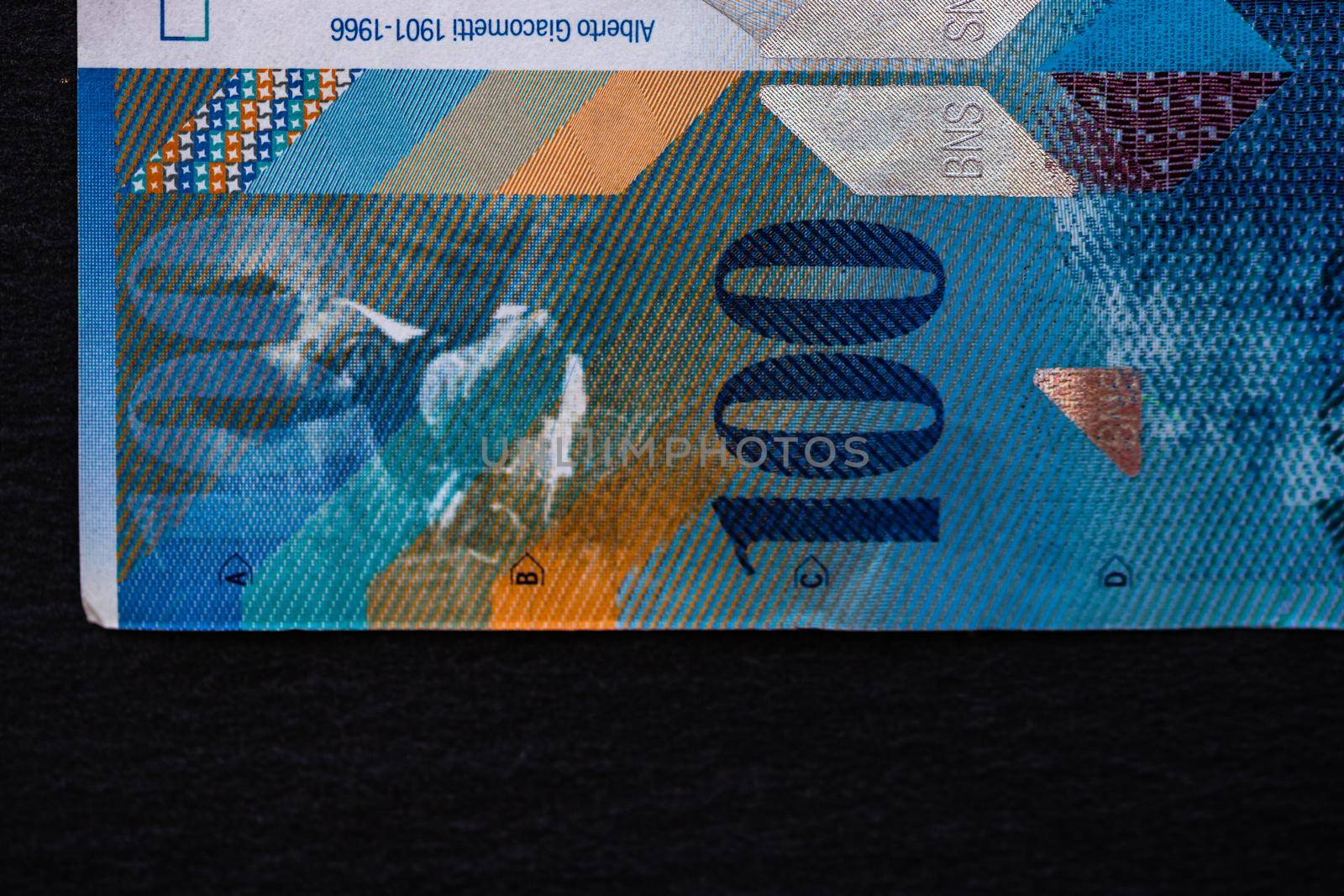 Selective focus on detail of 100 swiss franc banknote. Close up macro detail of money banknotes, swiss franc isolated. World money concept, inflation and economy concept by vladispas