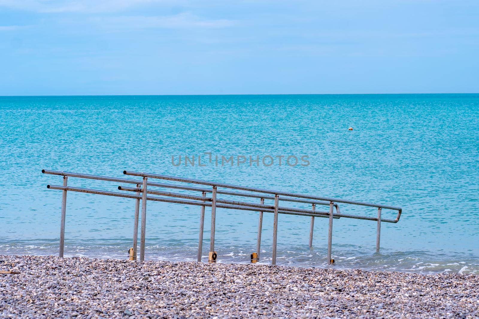 Handicapped metal chrome water guard rail outdoor sea shining blue, for waves railing from design from construction safety, europe black. Bulgaria ocean pier,