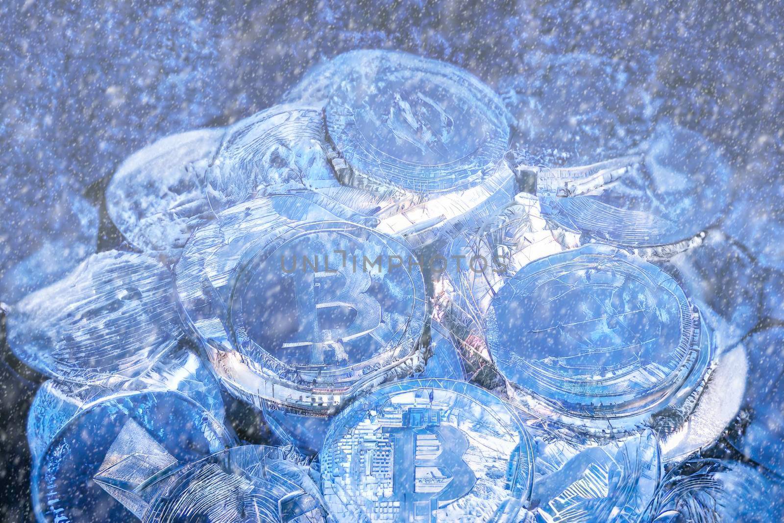 Concept for Crypto winter, Bitcoin in blue ice. Bitcoin price crash. Horizontal view of cryptocurrency tokens, including Bitcoin, Ethererum Ripple, and Litecoin saw from above on blue shiny texture background