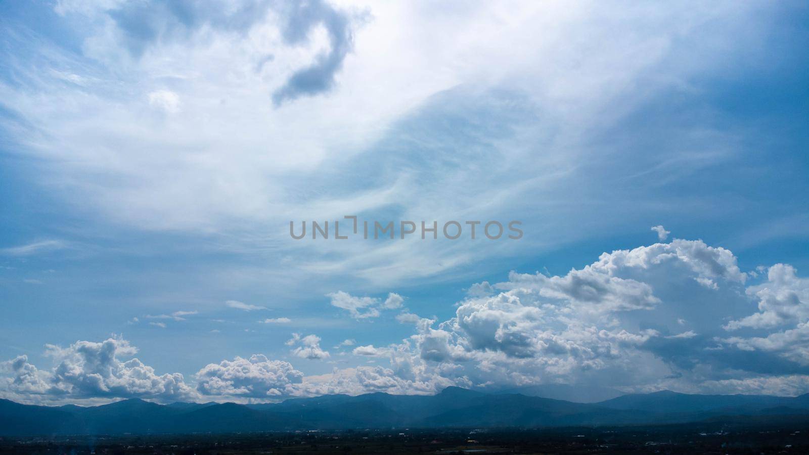 Aerial view of the blue sky with white clouds in summer day. Time lapse of white clouds and sunny blue skies. Natural background in motion. drone shooting clouds motion time by TEERASAK