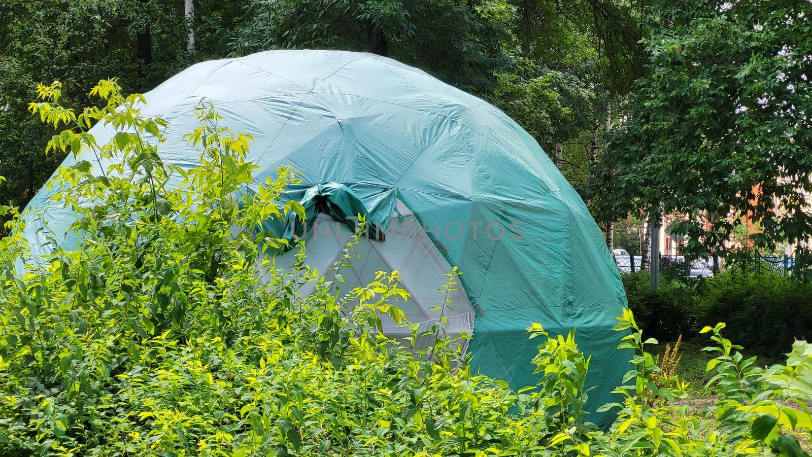 Large green dome geodesic tent for camping. Tourism concept.