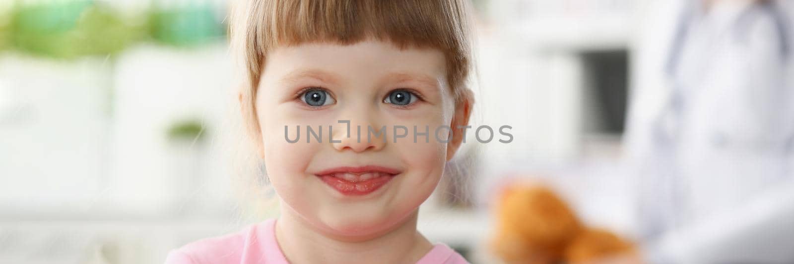 Portrait of little child at pediatrician reception, physical exam appointment. Healthy lifestyle, sickness, clinic test, high quality and trust concept