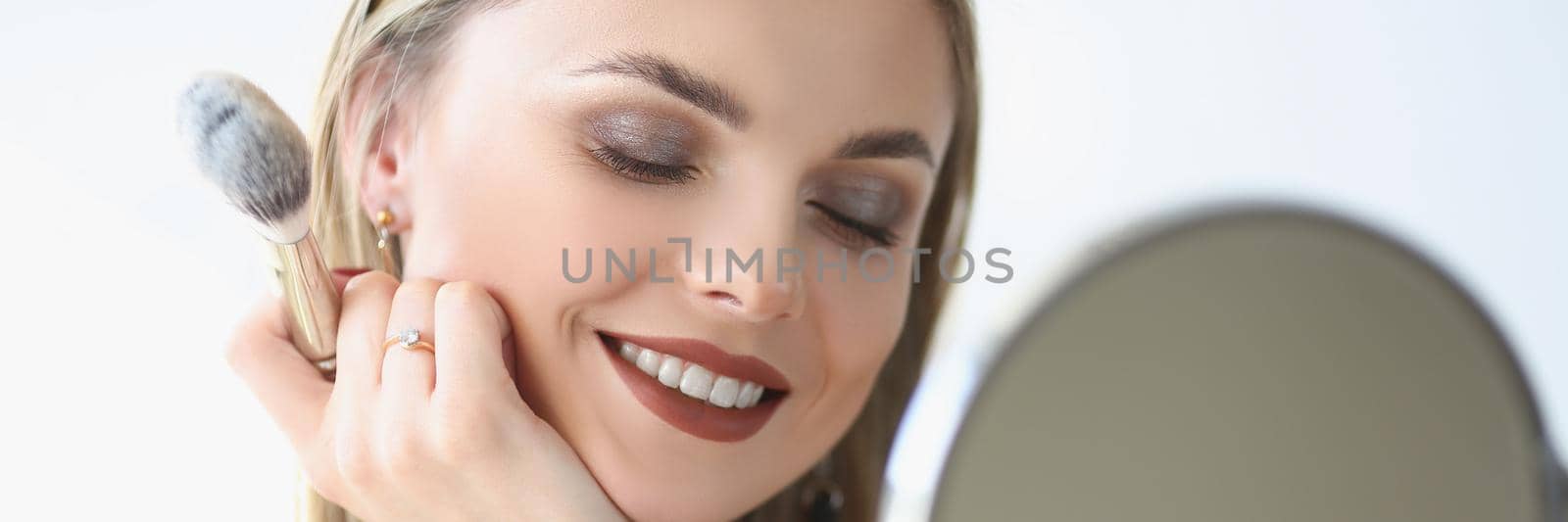 Elegant beautiful female with charming smile wearing makeup, glamour blonde lady by kuprevich