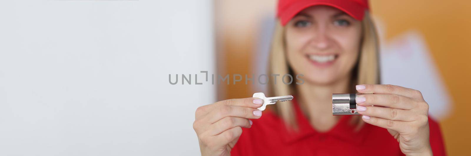 Portrait of real estate agent hold key and keyhole, woman realtor sell property, investment. Woman ready to give keys to new costumer. Real estate concept