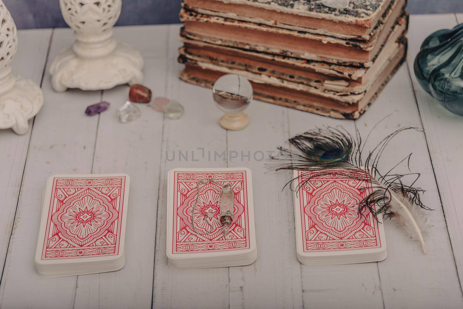 Black candle and old tarot cards on wooden planks. Halloween and fortune telling concept. Mystic background with occult and magic objects on witch table