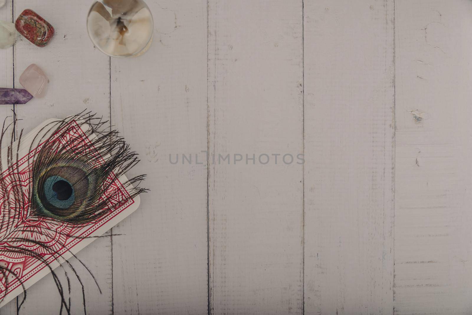 Black candle and old tarot cards on wooden planks. Halloween and fortune telling concept. Mystic background with occult and magic objects on witch table