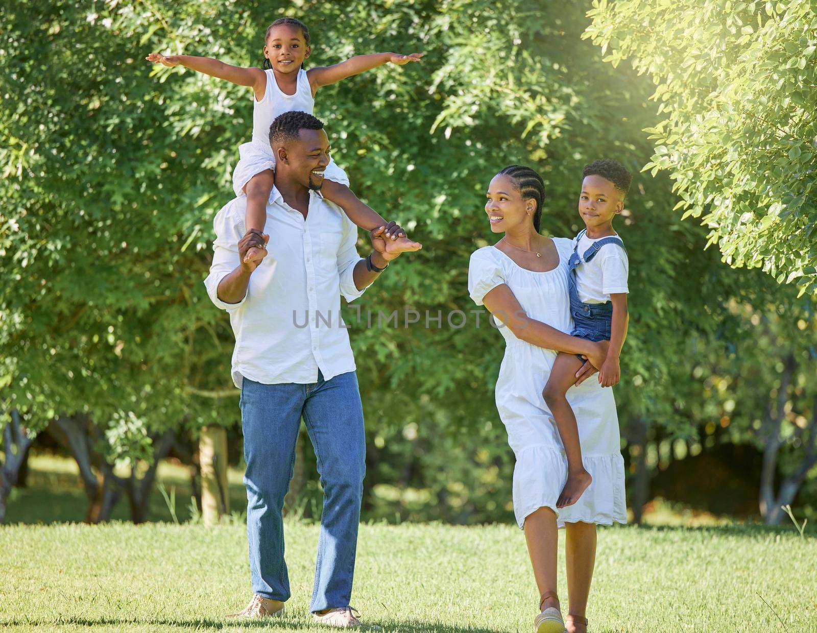 a couple spending time outdoors with their two children.