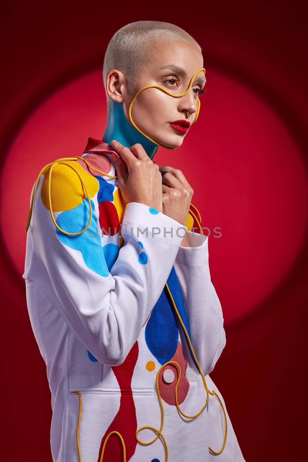 You wont find another like me. Studio shot of a stylish young woman posing against a red background. by YuriArcurs