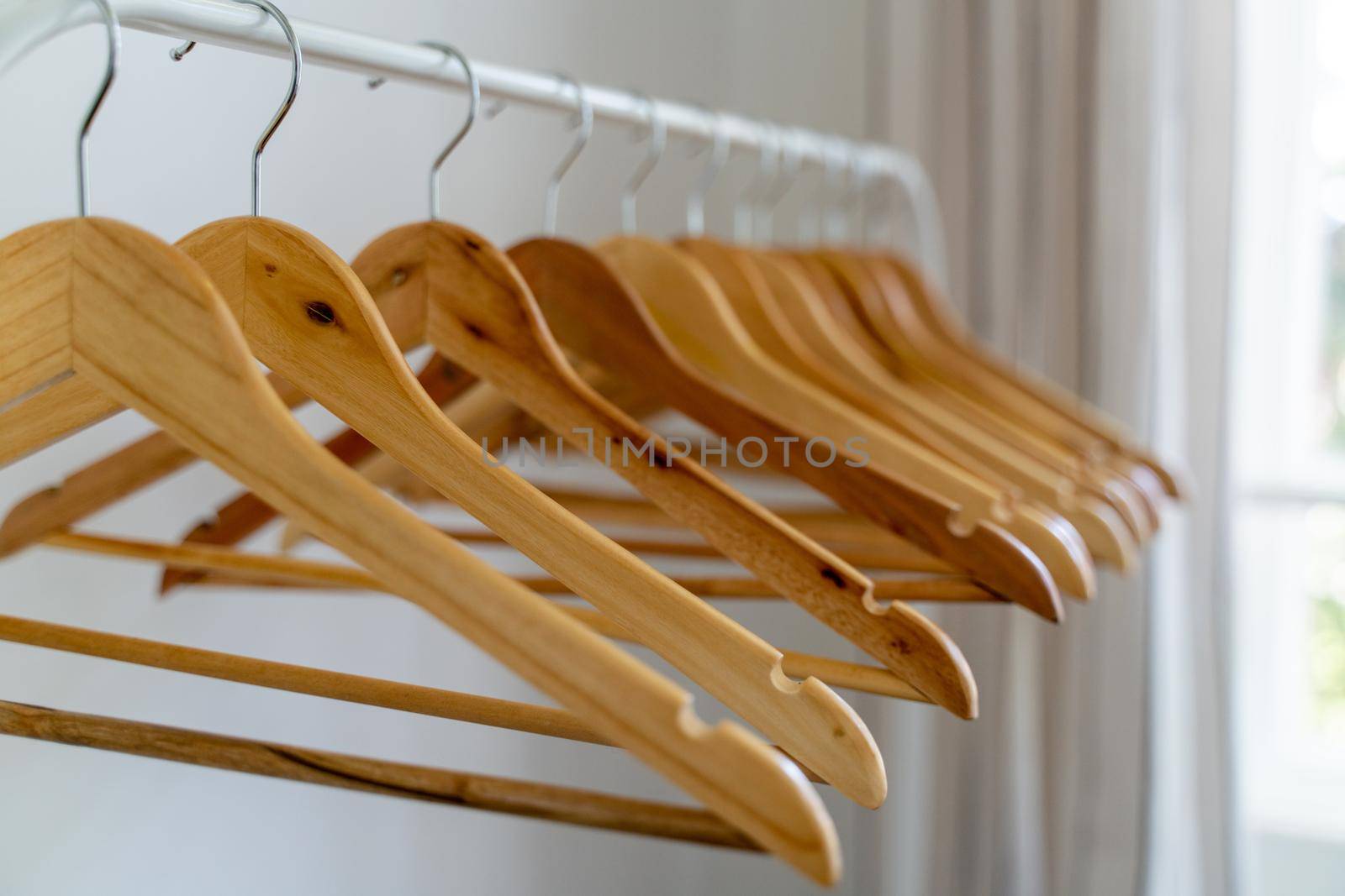 Close-up of wardrobe with wooden clothes hanger