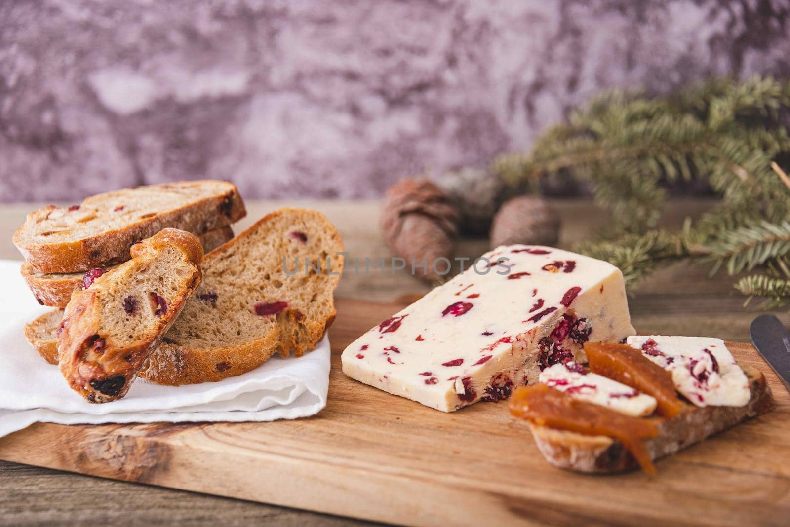 A closeup shot of Wensleydale cheese with cranberries and wine