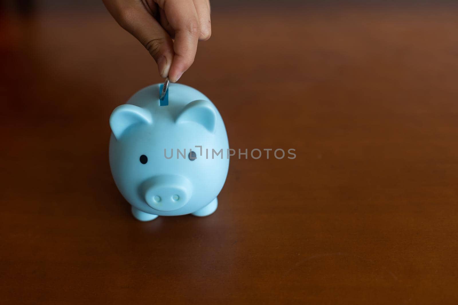 Pink piggy bank in the children's hands by Andelov13