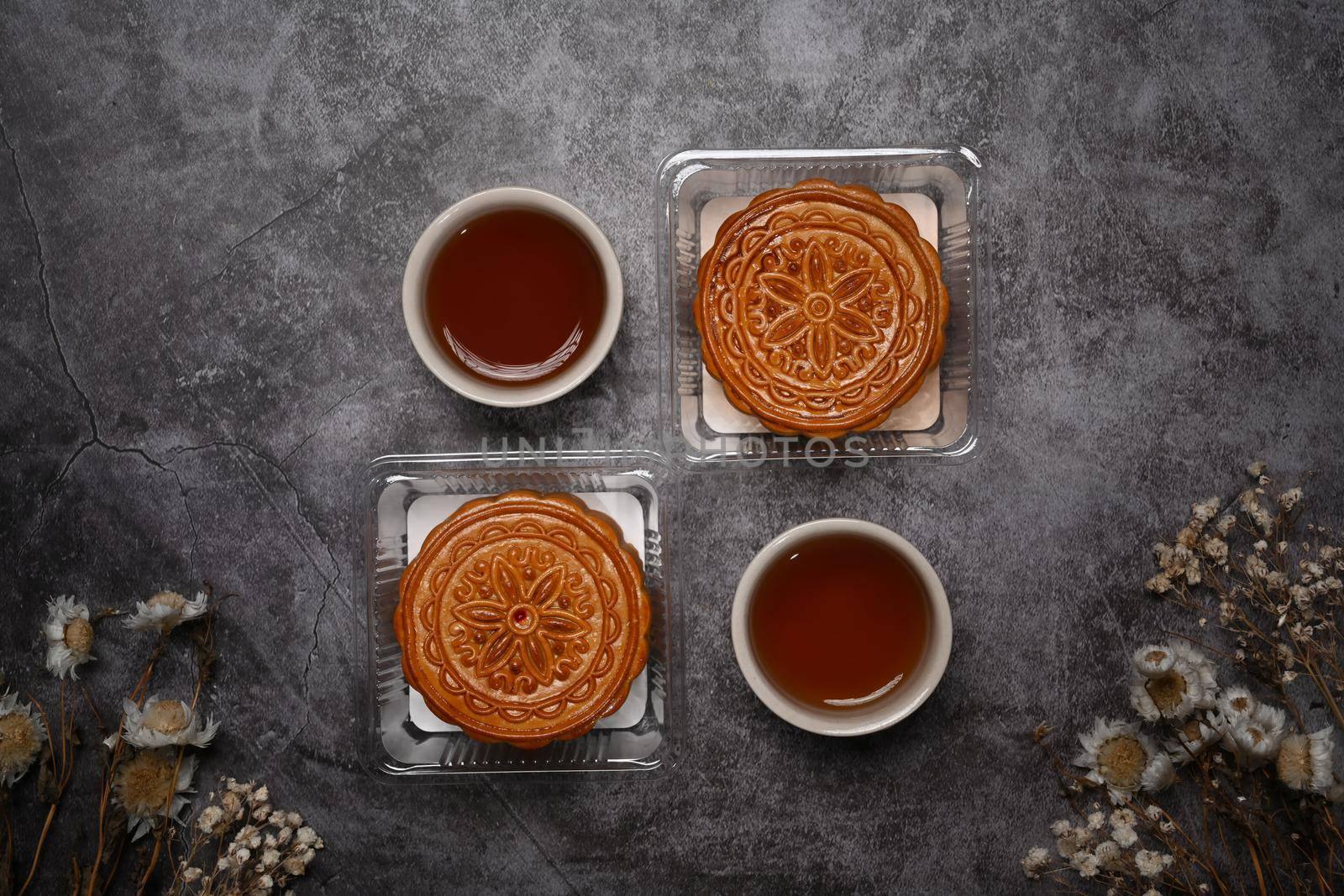 Flat lay Chinese traditional mid autumn festival moon cake on grey rustic background.